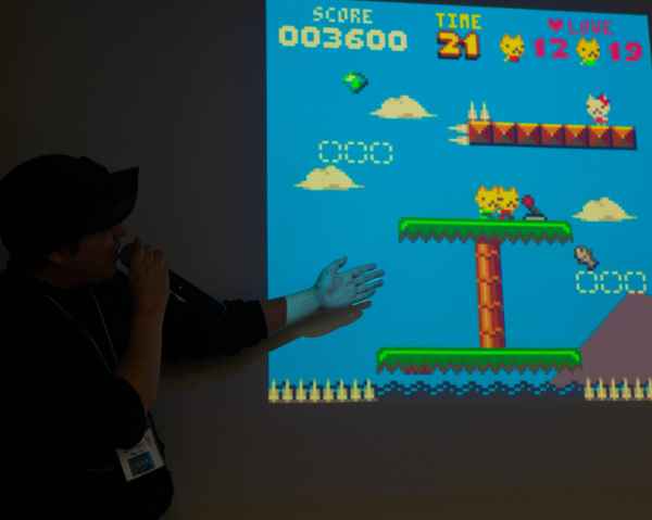 A jammer presenting one of the sites games, TRUST ME, a two player PICO-8 game.